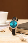 London Fog Analog Quartz Watch for Women with Turquoise Blue Round Dial, Roman Numeral Hour Markers, Crystal-Studded Bezel and Black Leather Strap - LFW20007-01